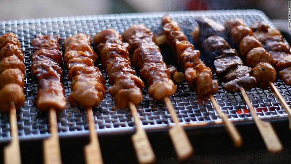 A variety of meats chicken, squid, beef, lamb are marinated and then seasoned, skewered, and grilled over thin elongated grills