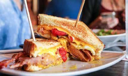 LOADED GRILLED CHEESE FRENCH DIP HANDHELDS LOADED GRILLED CHEESE Texas toast, American and cheddar cheeses, applewood bacon, ham, tomato and an over-medium fried egg. Served with kettle chips.
