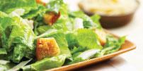Traditional Salad Selections Traditional Salads Traditional Caesar Chopped romaine with house-made croutons, tossed with parmesan and Caesar dressing. Serves 6: $21.99 12: $40.99 24: $79.