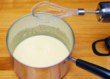 3 3 To start the custard, whip the egg yolks and sugar in a medium saucepan for several minutes until the mixture is smooth and golden.