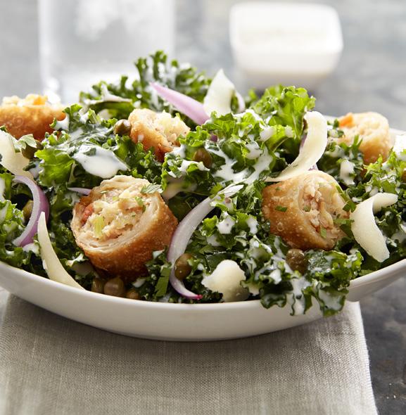 EGG ROLL CHICKEN CAESAR Yield: portion Minh 3 oz. Chicken Egg Roll 2 cups Lemon Marinated Kale 4 cup Red Onion, julienned 2 Tbsp. Caesar Dressing, prepared 4 cup Parmesan, fresh, shaved tsp.