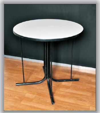 TABLES GLASS TABLE A low table with a glass surface and metal