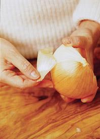 Peel back the onion skin, discarding the skin.