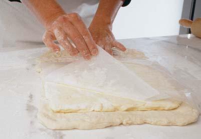 Fold the chilled dough and butter into a neat package Roll the chilled dough into an 18x12-inch rectangle on a floured surface.
