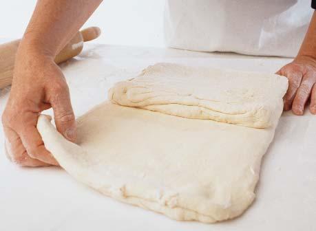 Rotate 90 degrees again and roll it out so that it doubles in length. Refold. After this set of two turns, seal the dough in plastic wrap and refrigerate for 2 to 4 hours.
