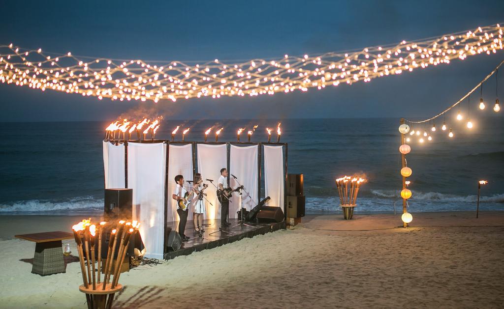 AFTER-DINNER CELEBRATION VENUE On the beach SET UP & DECORATION Beach Bonfire Oil Lamps & Torches around party area White pillows & sofa set up around party area Beverage Station with candles & light