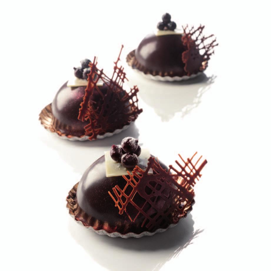 Recipe for 24 small dome-shaped cakes with a diameter of 7 cm Composition : Chocolate sponge, blackcurrant syrup, Cassis Peureux, vanilla cream, raspberry and blackcurrant chocolate mousse, crunchy