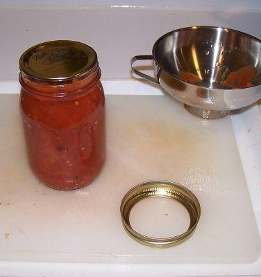 Step 9 - Fill the jars with sauces and put the lid and rings on Fill them to within ¼-inch of the top, seat the lid and hand-tighten the ring around them.