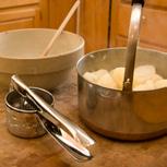 To help keep your potatoes warm, rice them into the empty pot you used for boiling.