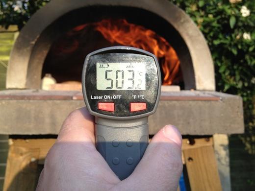 Move the burning wood to one side or the back of the oven. Its a preference thing. Let the base cool off a little and you are ready to make pizza!