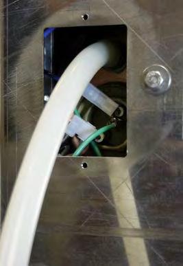Turn the power switch to the off position and unplug the machine from the outlet. There is an access panel on the bottom of the machine. Remove the 2 phillips screws to remove the access panel.