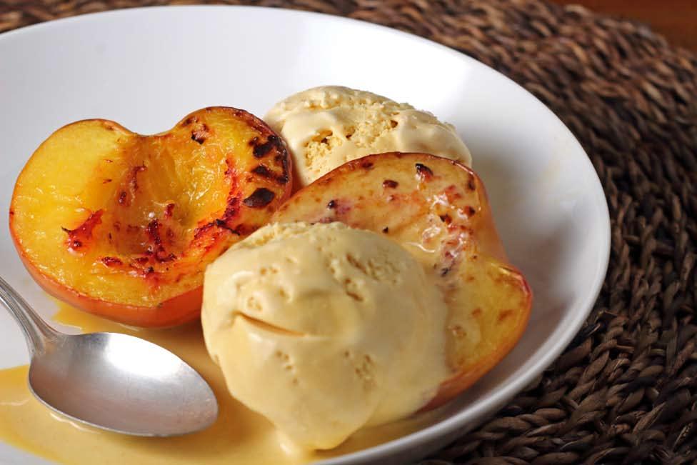 PREP TIME 10 MINUTES COOKING TIME 5-6 MINUTES 4 RIPE PEACHES, SPLIT IN HALF AND SEED REMOVED 1 CONTAINER OF VANILLA OR SALTED CARAMEL ICE CREAM 2 TABLESPOONS BUTTER OR COCONUT OIL, MELTED 1 TEASPOON