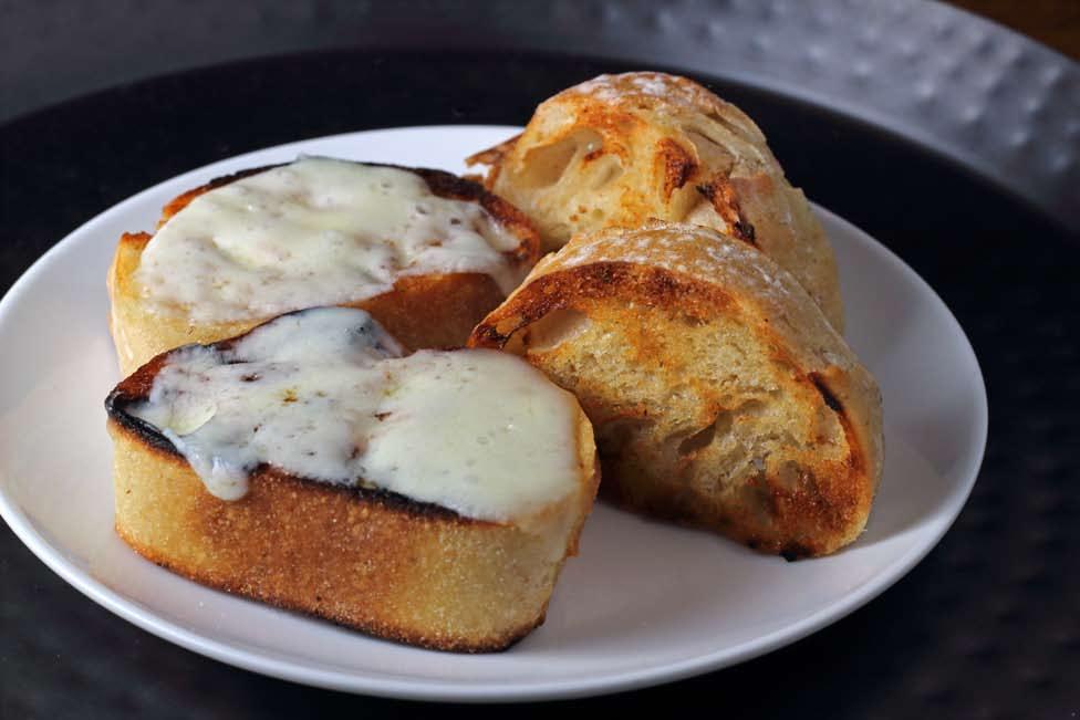YIELD 4-6 SERVINGS PREP TIME 15 MINUTES COOKING TIME 10 MINUTES 3 CLOVES OF GARLIC, PEELED ½ CUP BUTTER, SOFTENED 1 LOAF OF HEARTY BREAD PROVOLONE OR MOZZARELLA CHEESE, IF DESIRED Garlic Bread