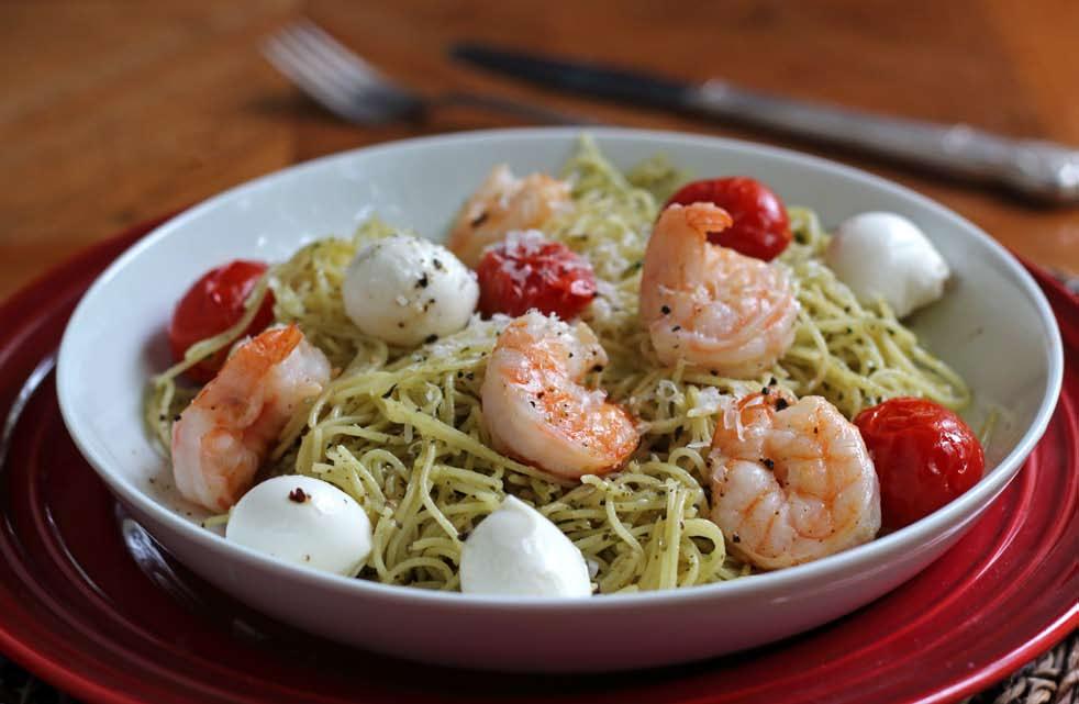 PREP TIME 5 MINUTES COOKING TIME 5-6 MINUTES 1 POUND SHRIMP, CLEANED AND DEVEINED 1 PINT CHERRY TOMATOES ½ CUP AND 2 TBSP OLIVE OIL, DIVIDED 2 TABLESPOONS BUTTER ½ CUP PREPARED PESTO FRESH MOZZARELLA