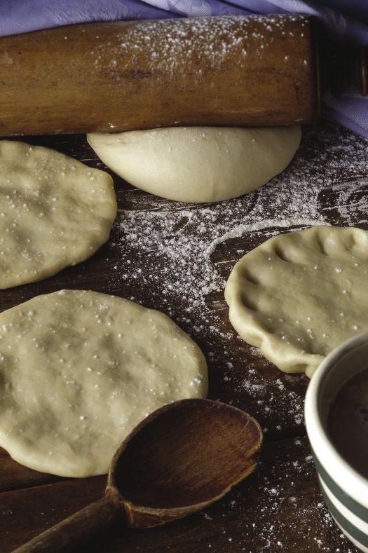 With machine running, slowly pour in oil and yeast mixture and process to form a rough dough.