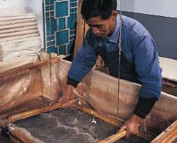 Modern papermaking A modern artist demonstrates an ancient way of making paper. Papermaking today is a huge international industry.