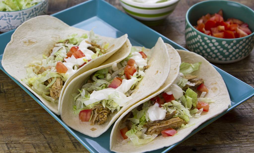 Pour chicken broth over roast, cover, and cook on high for 4-5 hours or low for 6- hours. Shred pork in the slow cooker and toss with juices. Place shredded pork in tortillas.