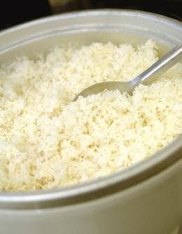 Commercial Steamer Rice may be cooked in a commercial steamer in essentially the same way as oven-simmered rice except the pan is not covered and the cooking process is completed in about half the