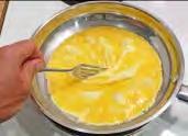 Cut about as much butter or margarine with a table knife as shown in (1) below and rub it off the knife using the pan edge as shown