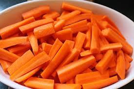 Prepare the vegetables: 1. Peel and slice the carrots.