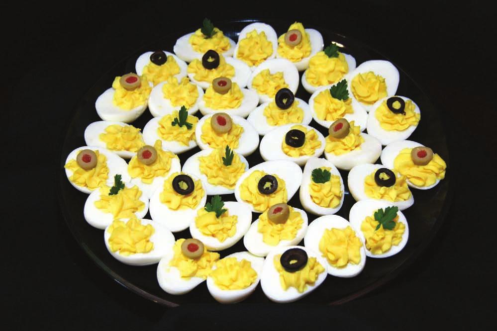 deviled eggs Tender cooked eggs are stuffed with creamy yolks and topped with a colorful light garnish.