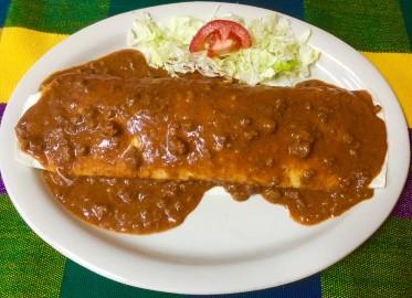 75 Two Shredded Chicken Enchiladas Topped with Green Tomatillo Sauce. Served with Rice and Beans.