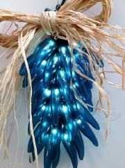 Turquoise Ristra Try a tradition of the southwest with one of our lighted chili ristras, complete with a raffia bow and a raffia hook for hanging.
