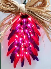 Red Hot Mamas Ristra Red/Purple Try a tradition of the southwest with one of our lighted chili ristras, complete with a raffia bow and a raffia hook for hanging.