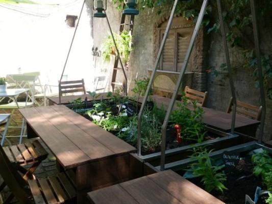 Wooden planks and chairs encircle L Albero s working garden, filled with aromatic vegetables and herbs like rosemary, lavender, and petunias. It s something of an Italian tradition, Monia explains.