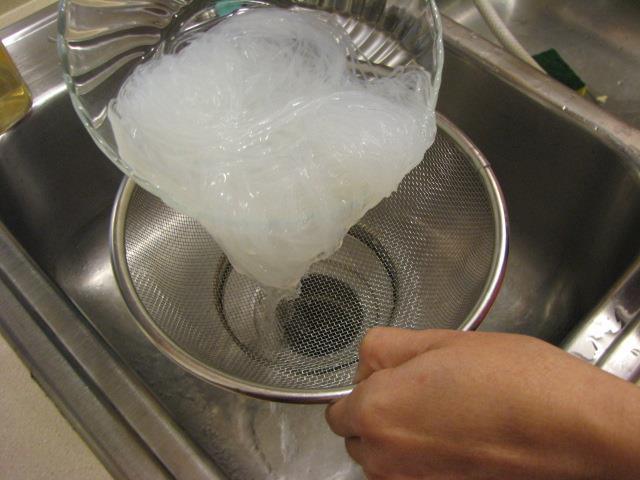 Drain the noodles in a strainer over a sink.