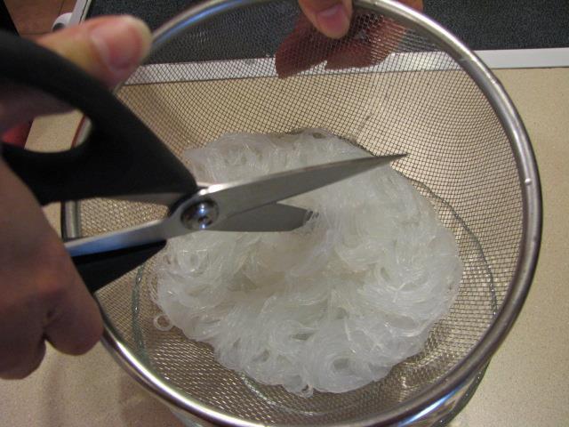 You can use scissors while they are still in the strainer, or