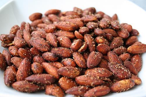 Sweet & Spicy Roasted Almonds [Serves 4]** 1 cup raw almonds (ideally soaked overnight) 1 ½ tsp. coconut oil 1 tsp. garlic powder 1 tsp. paprika ½ tsp. cinnamon ½ tsp. cayenne ¼ tsp.