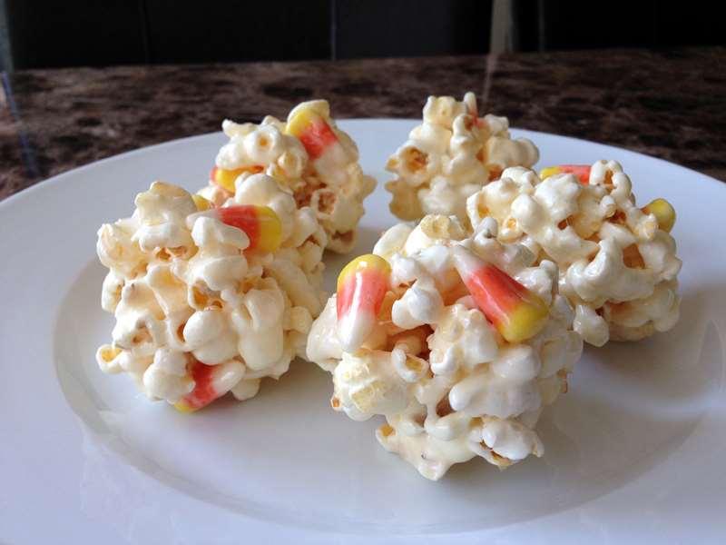 Idea #7: Candy Corn Popcorn Balls Here s a cute recipe from About.com. You could do this with popcorn, as shown below, or make a Rice Krispies treat instead.