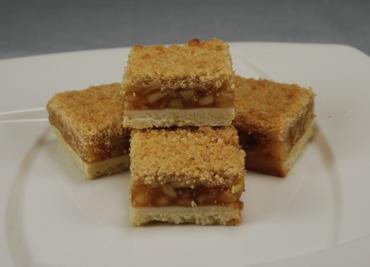 Apple Crumb Cake Bar A sheet of cookie dough under cubed apple filling