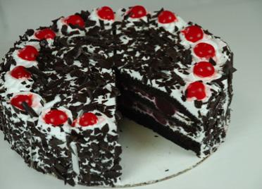 Black Forest Torte Moist chocolate cake layers filled with whipped cream and liqueur soaked cherries.