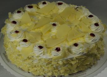 whipped cream icing and garnished with shavings of white chocolate.