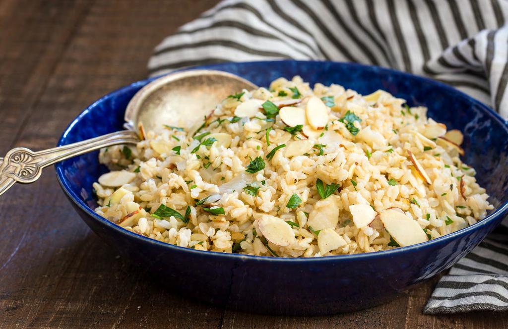 VEGETARIAN DISHES Brown Rice Pilaf 1 cup brown rice 1 yellow onion, diced 2 ¼ cups water or stock (vegetable or chicken) ¼ cup sliced almonds, toasted Chopped flat leaf parsley for garnish Kosher