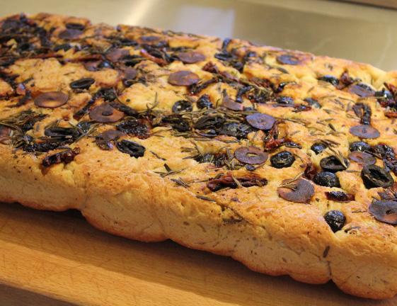 Focaccia Bread 750 g strong flour 750 g plain flour 75 g yeast 150 ml olive oil 500 ml water (approx) 30 g salt 10 g sugar 100 g green olives roughly chopped 40g rosemary, removed from the stalks and