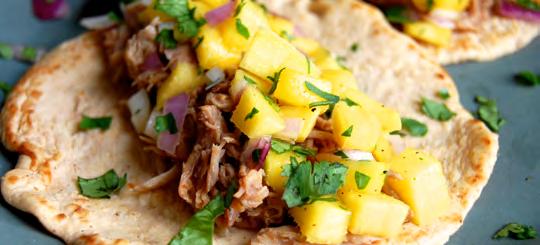 Pulled Pork Tacos with Mango Salsa The pork for the tacos is made in the slow cooker with barbeque and adobo sauce for added flavor.