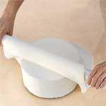 Step 3 Gently lift fondant over rolling pin or slip cake circle under fondant to move; position on cake.