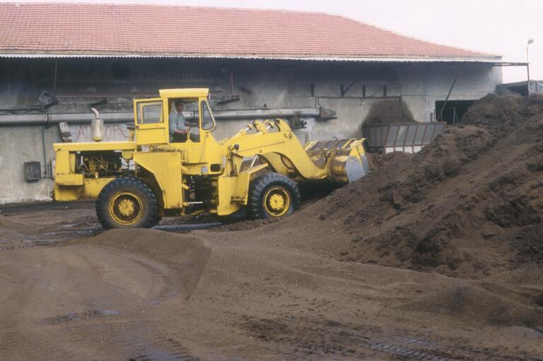 Olive pomace being loaded into a