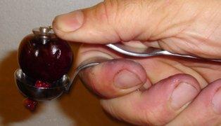 If you have a food mill or other strainer, or you are using frozen pitted cherries, skip to step 3. If you don't have a food mill or strainer, you'll need to do it manually.