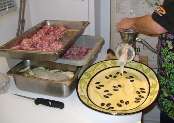 Stuffing the Sausage Drop a ball of meat in the grinder opening Turn level and push meat down When it gets to the funnel opening pinch and old casing Turn the