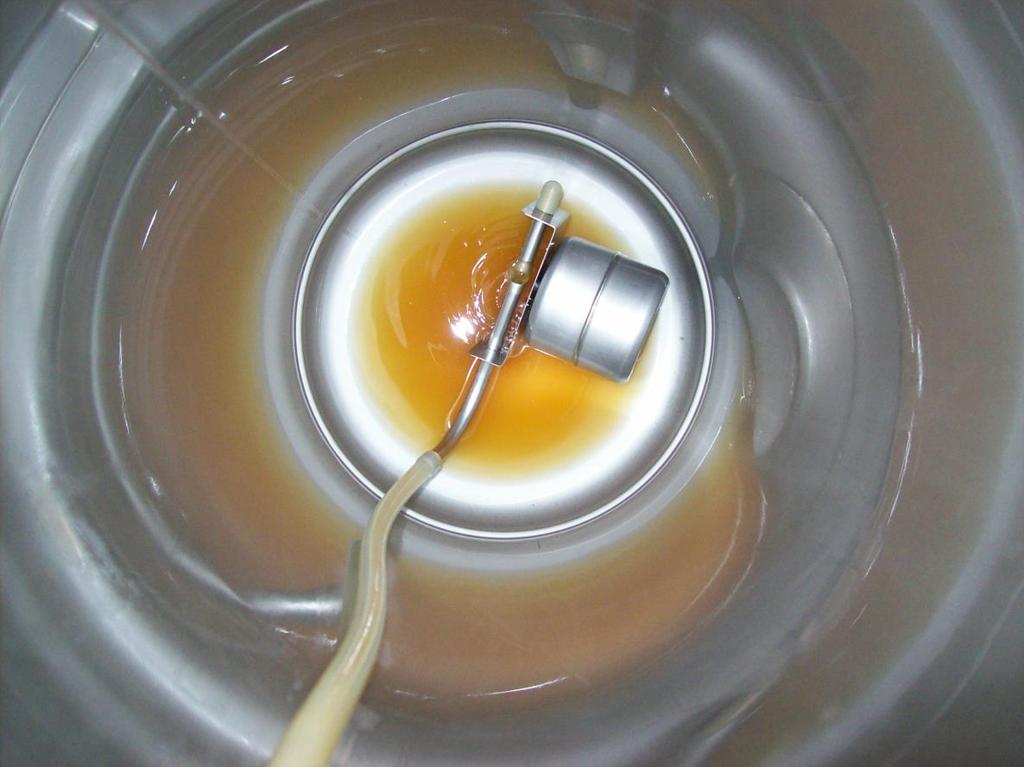 This picture shows the initial transfer into the keg. This is done at a very slow rate. Notice there are very few bubbles present.