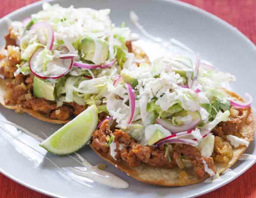 TOSTADAS Fried flat corn tortillas, topped with refried beans, your choice of meat, lettuce, cheese and sour cream. Special meat extra*. Frijoles 2.