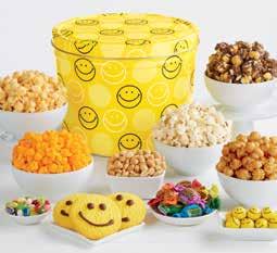 99 A A SMILEY DOT TIN GRAND SNAK ASSORTMENT A 2-gallon tin is filled to the brim with Smiley Face Sugar ookies, Jelly ellies, Sour Sassy Taffy, Smiley Face hocolates, Dry-roasted Peanuts, and 5