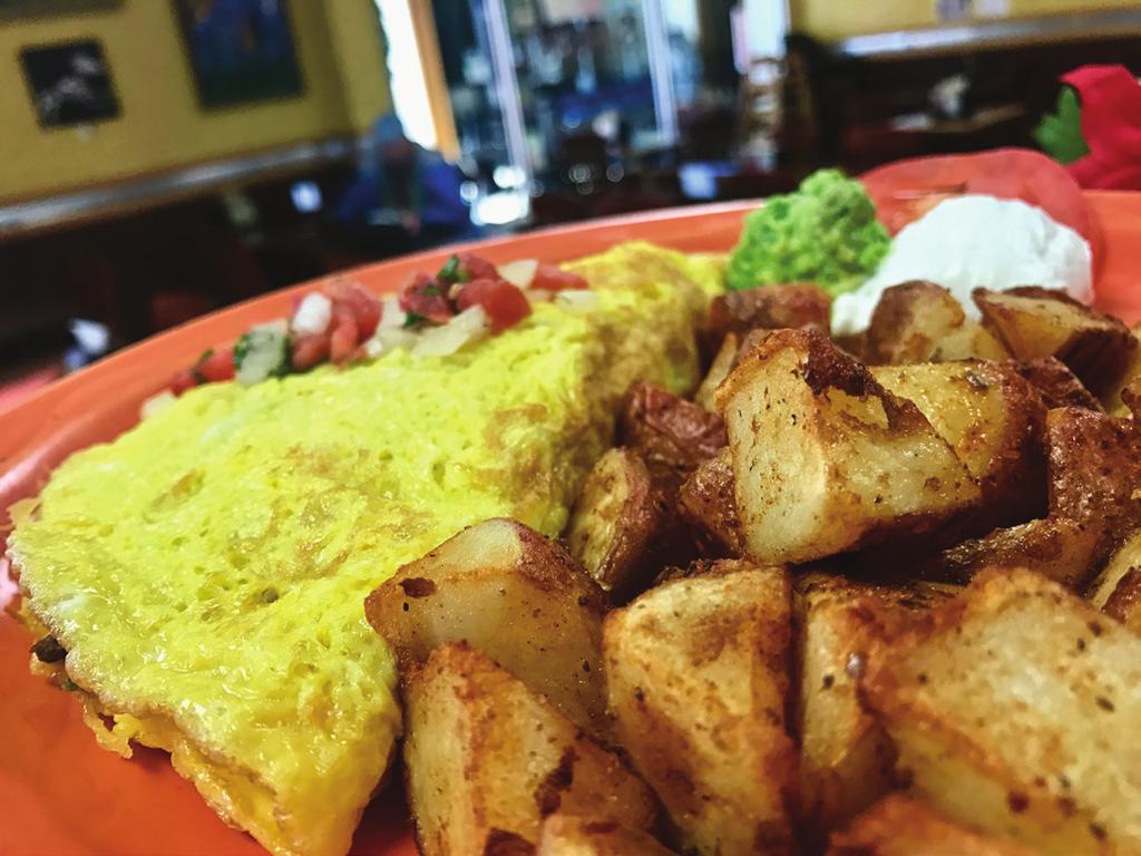25 Two eggs over easy on top of deep fried corn tortillas, smothered in our pork or vegetarian green chile and sprinkled with cheese, served with a side of rice and beans Sancho s