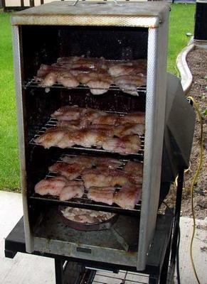 Little Chief Smoker, loaded with three racks of brined and seasoned catfish fillets.
