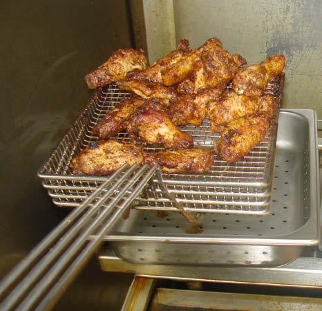 HOLDIING//SERVIING Prior to getting started, place two ½ size 2 inch deep perforated pans side by side directly above the modified grill.