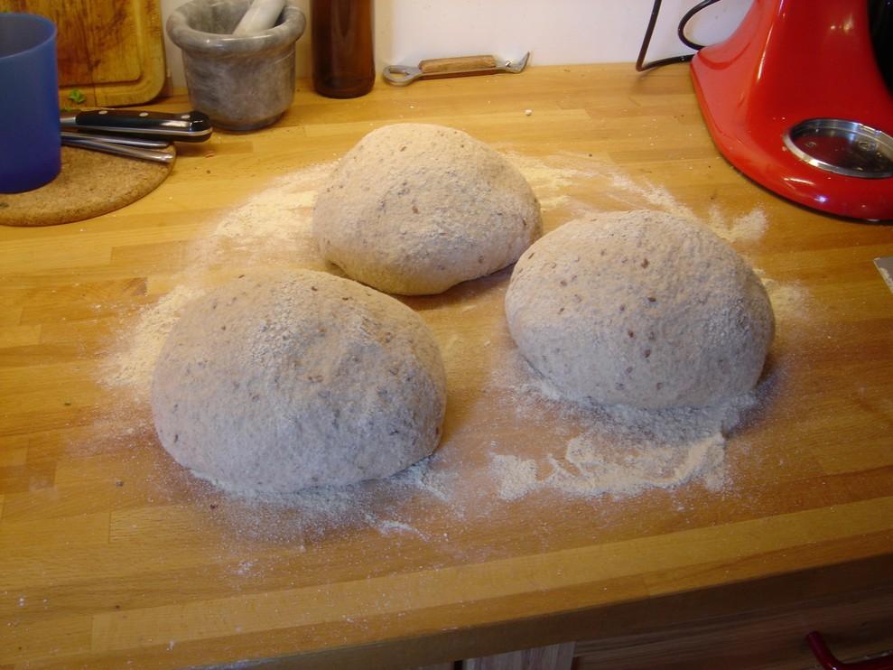 To the intermediate dough add 28 oz (800 g) of whole wheat flour, the salt water and the linseed mixture. Mix all ingredients and turn them out onto a counter.